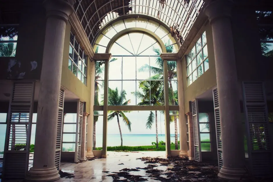 Explore the ruins of an old resort with stunning ocean views in Punta Cana. Captivating scene of decay meets paradise.